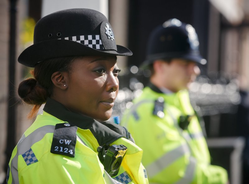 A female police officer stares into the distance